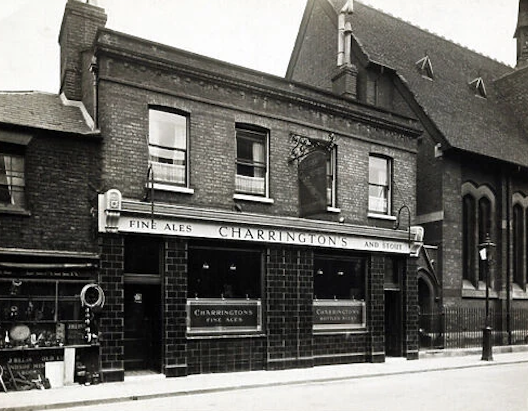 Historical street scene with Charrington's Fine Ales pub and surrounding buildings